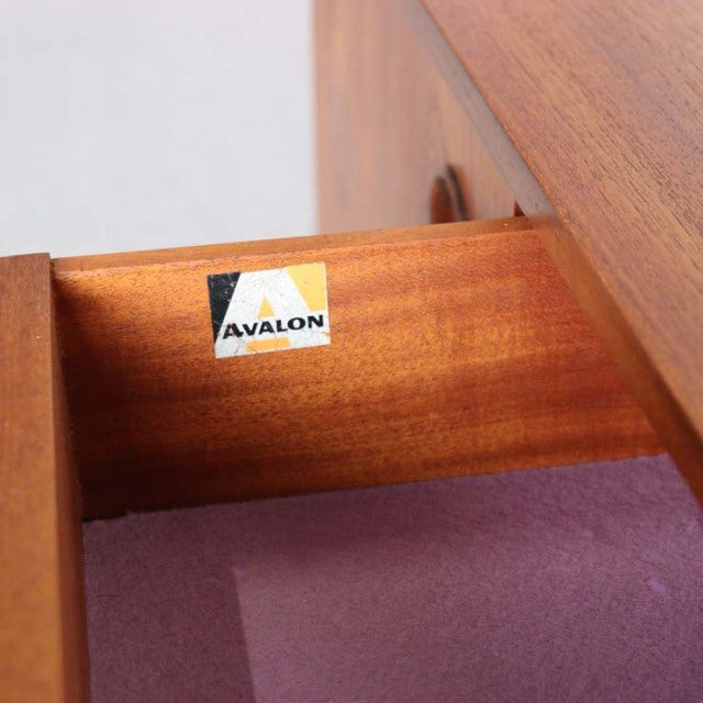 Close-up of teak drawer interior with Avalon brand label, showcasing vintage British mid-century craftsmanship and smooth.