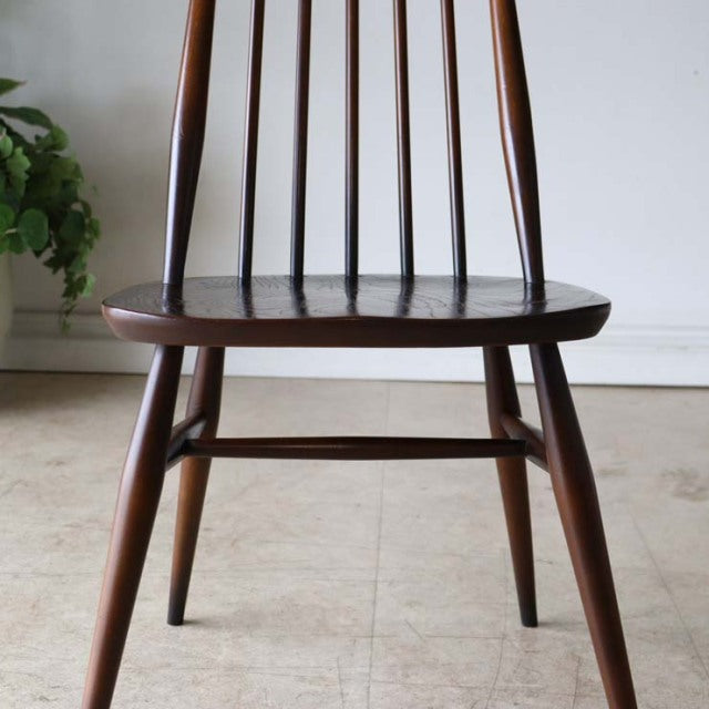 ERCOL Goldsmith highback Windsor chair in brown teak with slender spindle back and tapered legs, vintage British mid-century .