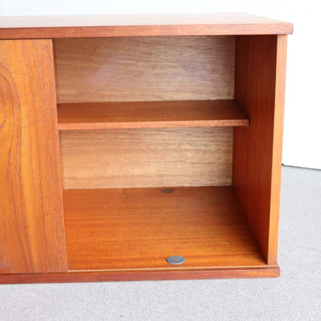 Vintage teak mid-century British Avalon sideboard open compartment with wood grain and smooth finish.