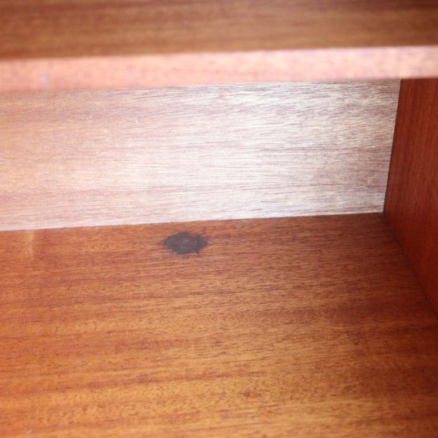 Close-up of vintage teak wood grain inside Avalon mid-century British sideboard showing smooth surface and warm.