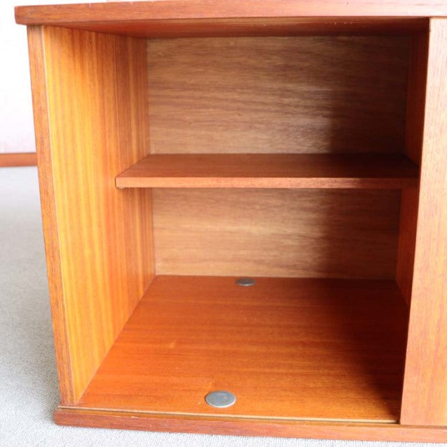 Open teak cabinet interior with visible wood grain, mid-century British Avalon sideboard shelf.