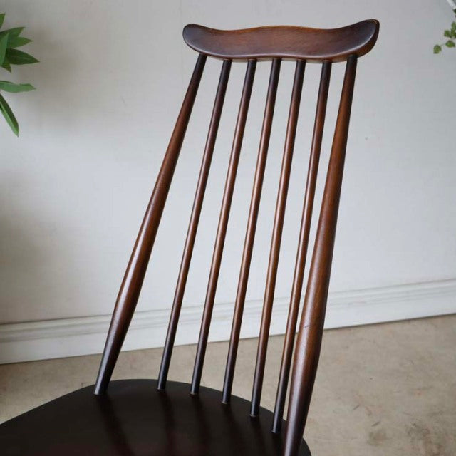 Vintage mid-century British Ercol Goldsmith high-back chair in rich teak with slender vertical spindles and gracefully.