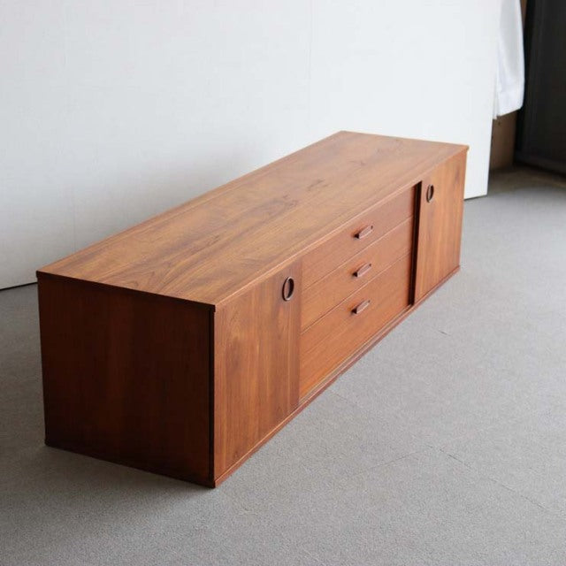 Mid-century British AVALON teak sideboard with rich wood grain, three central drawers, and circular recessed handles on.