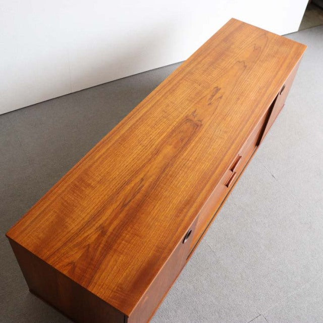 Vintage teak sideboard by Avalon with sleek mid-century British design, smooth wood grain, and tapered legs.