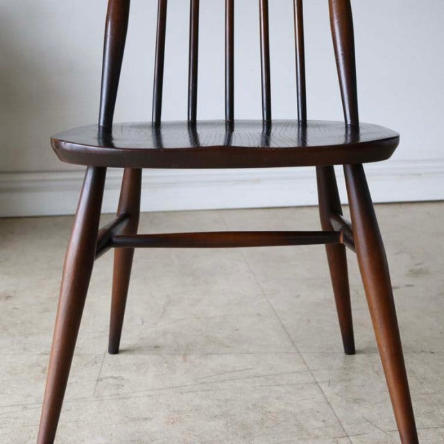 Vintage teak British mid-century dining chair by Ercol with spindle back and tapered legs.