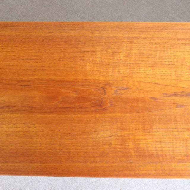 Close-up of vintage teak wood grain on mid-century Avalon British sideboard with warm honey tones and smooth finish.