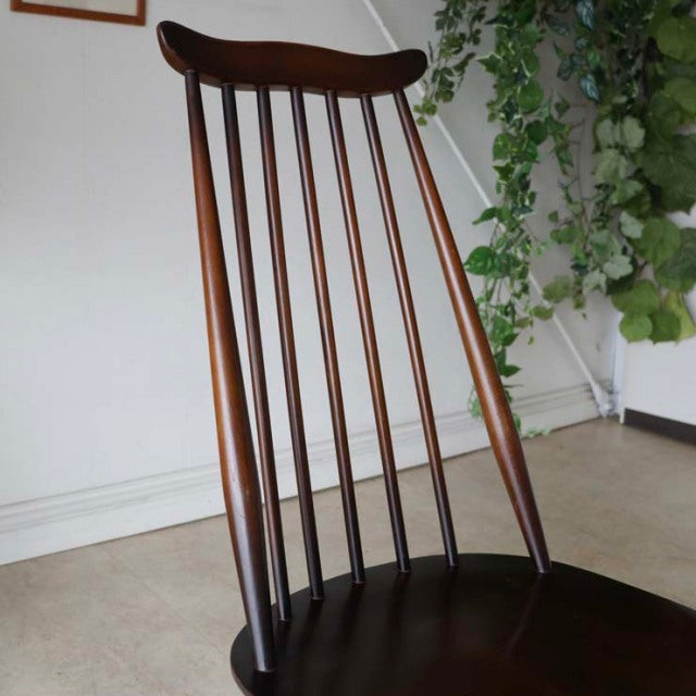 Mid-century British vintage Ercol Goldsmith dining chair in teak with tall spindle back and curved top rail.