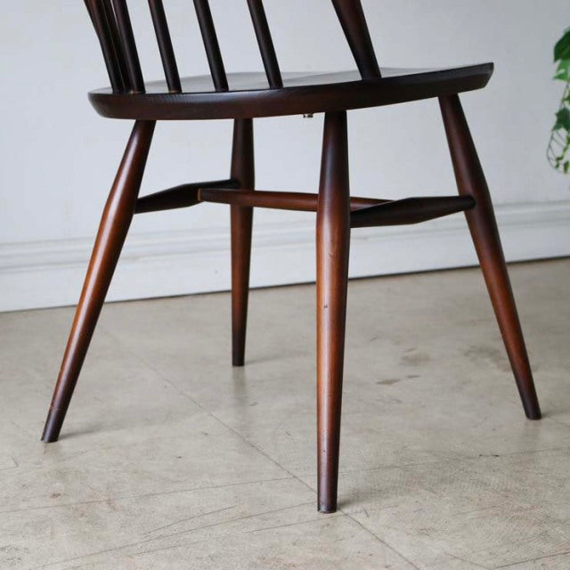 Set of four vintage British mid-century Ercol Goldsmith high-back dining chairs in rich teak with visible wood grain and.