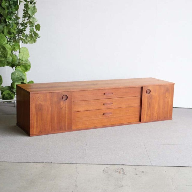 Vintage teak AVALON sideboard with mid-century British and Danish design, featuring circular wood handles and tapered legs.