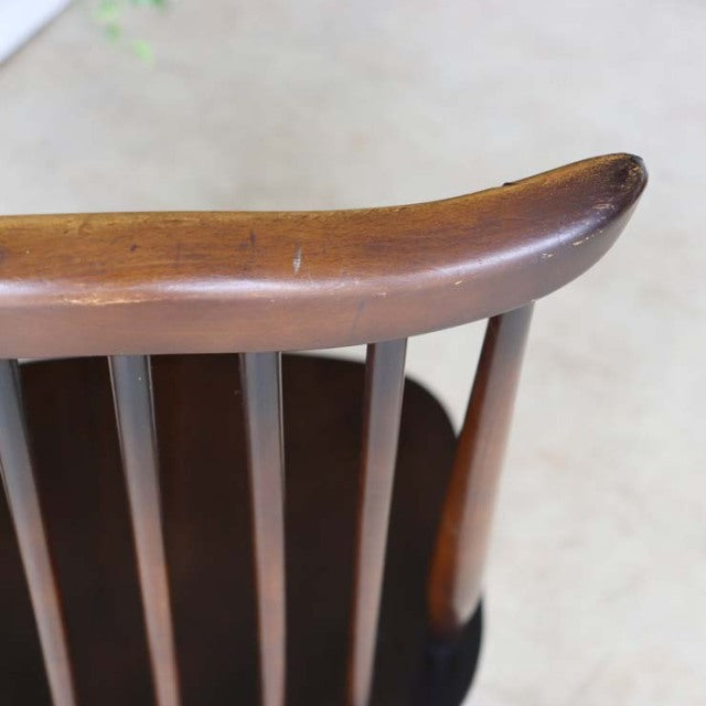 Close-up of vintage mid-century British Ercol Goldsmith dining chair with curved teak backrest and vertical slats showing.