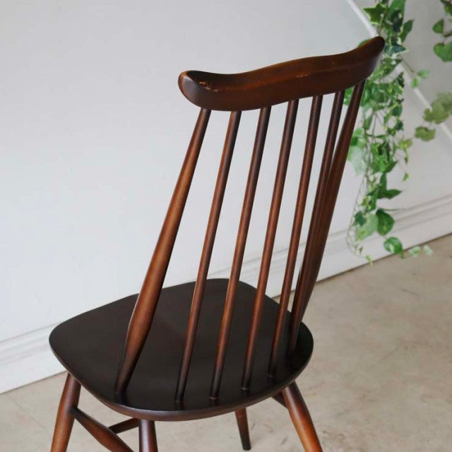 Vintage British mid-century Ercol Goldsmith dining chair in rich teak with spindle back and contoured seat.