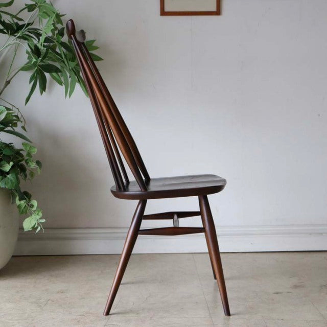Vintage teak mid-century British Ercol Goldsmith dining chair with slender spindle back and tapered legs.