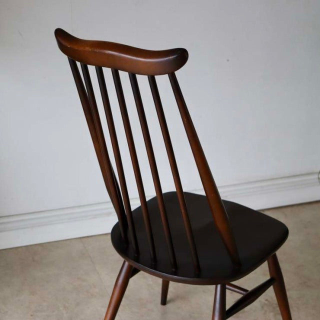 Vintage British mid-century Ercol Goldsmith dining chair in teak with curved spindle back and angled legs.