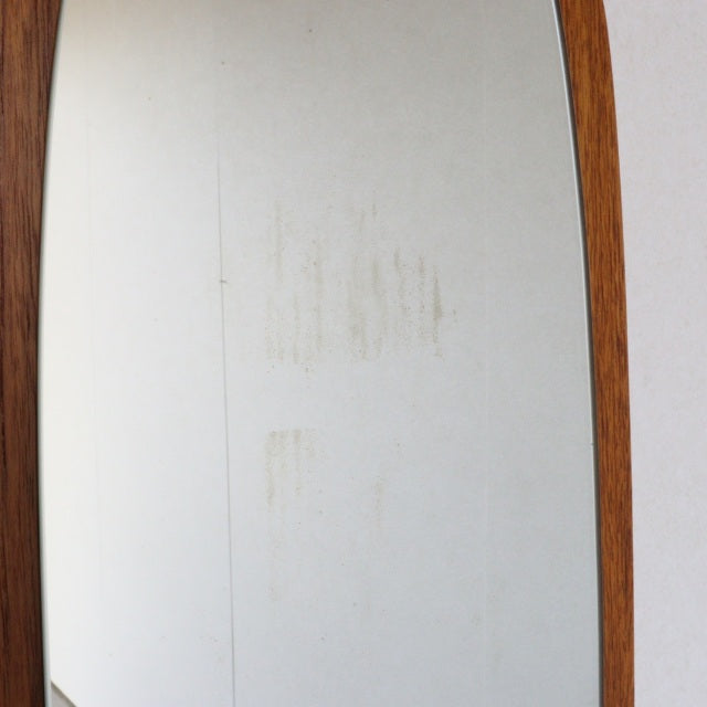 Vintage mid-century British teak wall mirror with tall, slender rectangular frame and rich wood grain finish.
