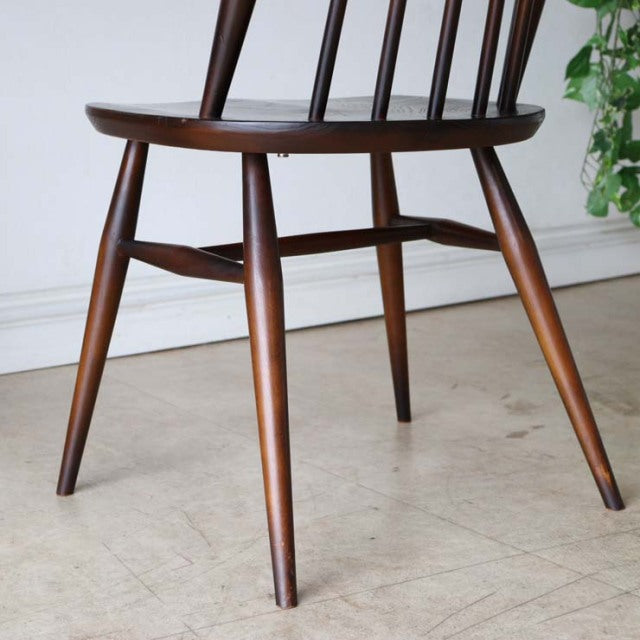 Mid-century British vintage Ercol Goldsmith dining chair in teak with spindle back and tapered legs.