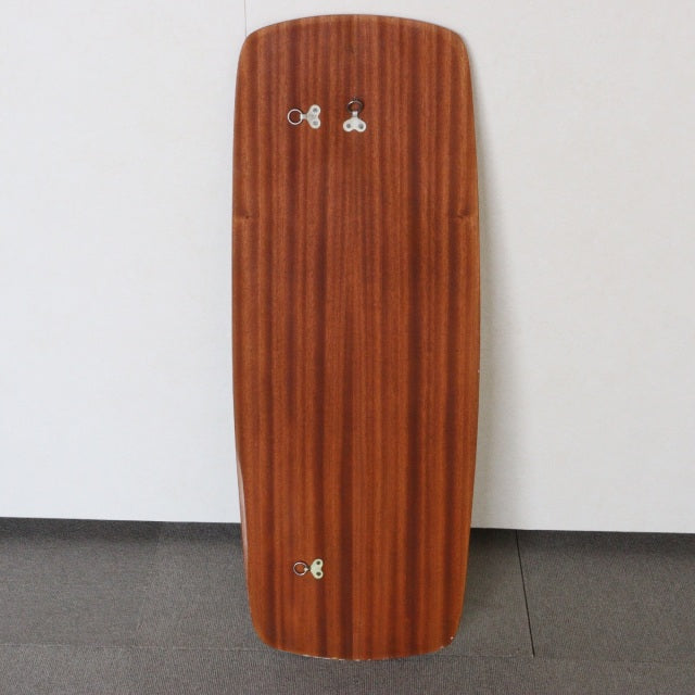 Vintage British mid-century teak wall mirror with elongated vertical form and rounded corners, smooth wood grain surface,.