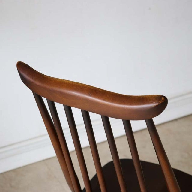 Vintage mid-century British Ercol Goldsmith dining chair in teak with curved spindle backrest and smooth wood grain finish.