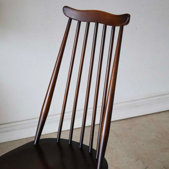 Vintage British mid-century teak dining chair with slender vertical spindles and curved top rail.