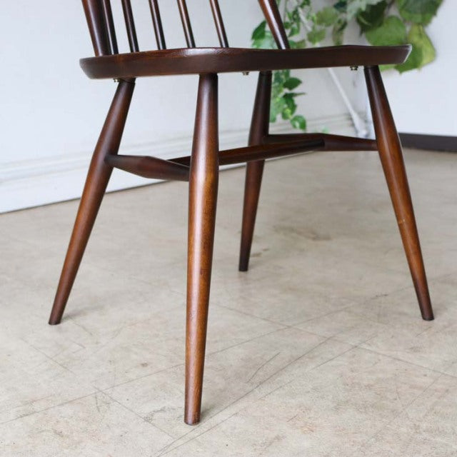 Mid-century British vintage teak dining chair with tapered round legs and visible wood grain, ERCOL Goldsmith design.