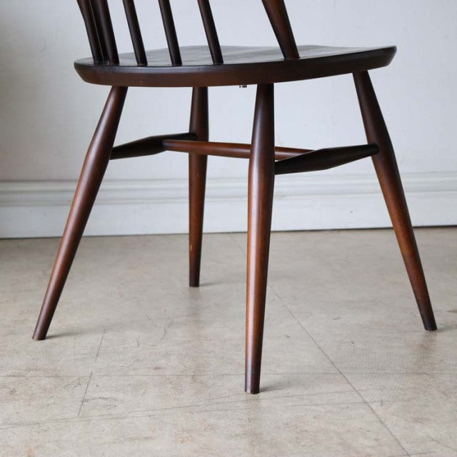 Mid-century British vintage Ercol Goldsmith dining chair in teak with tapered legs and curved seat detail.