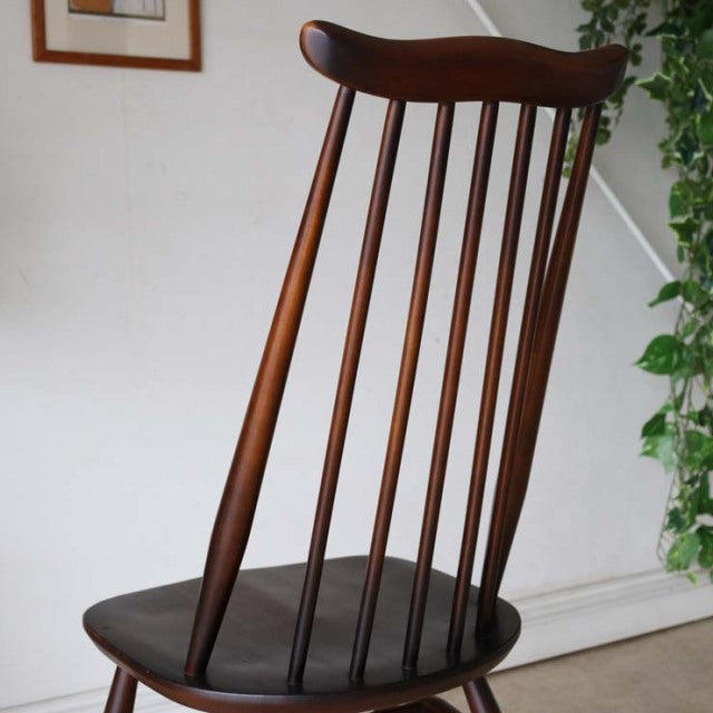British mid-century vintage Ercol Goldsmith dining chair in rich teak with slender spindle back and tapered legs.