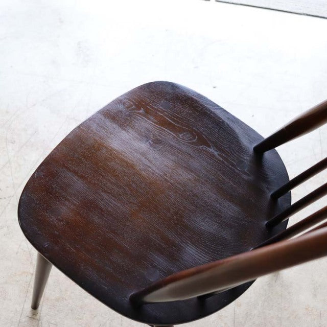 Set of four vintage British Ercol Goldsmith mid-century teak high-back dining chairs with curved slat backs and tapered legs.