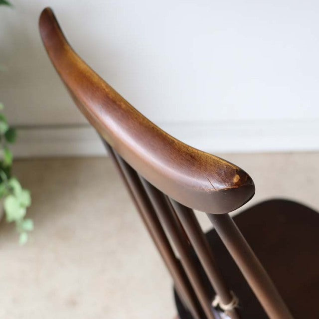 Vintage British mid-century teak dining chair with smooth curved backrest and slender spindle legs from ERCOL.