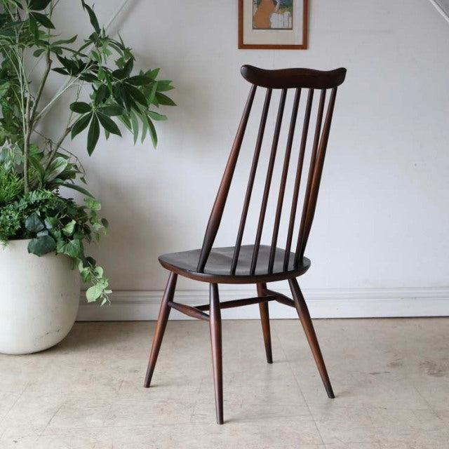 Vintage British mid-century teak dining chair by Ercol with slender spindle back and tapered legs.
