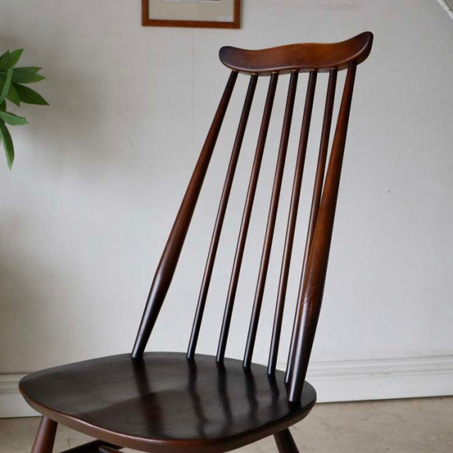 Vintage British mid-century Ercol Goldsmith teak high-back dining chair with slender vertical spindles and curved top rail.
