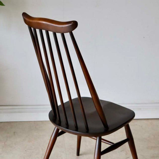Vintage British mid-century Ercol Goldsmith dining chair in rich teak with elegant spindle back and tapered legs.
