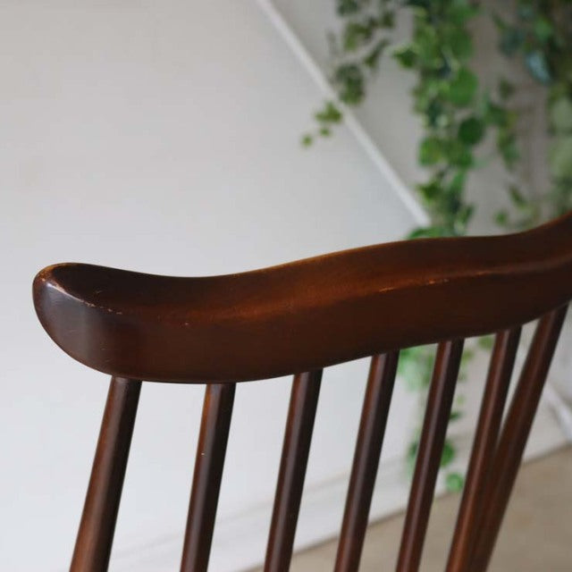 Mid-century British vintage Ercol Goldsmith dining chair in rich teak with curved top rail and slender vertical spindles.