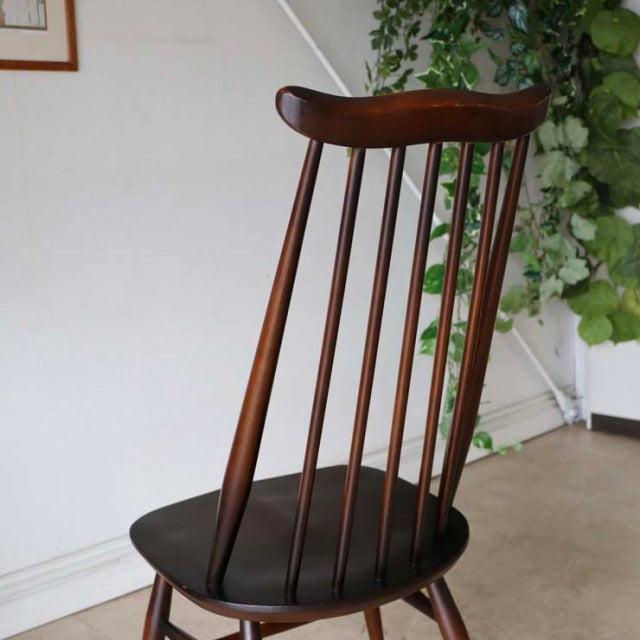 Vintage British mid-century teak dining chair by Ercol with curved top rail and slender spindle backrest.
