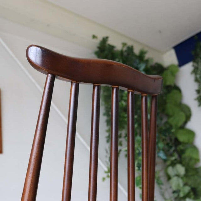 British vintage mid-century teak dining chair by Ercol with curved top rail and slender vertical spindles.