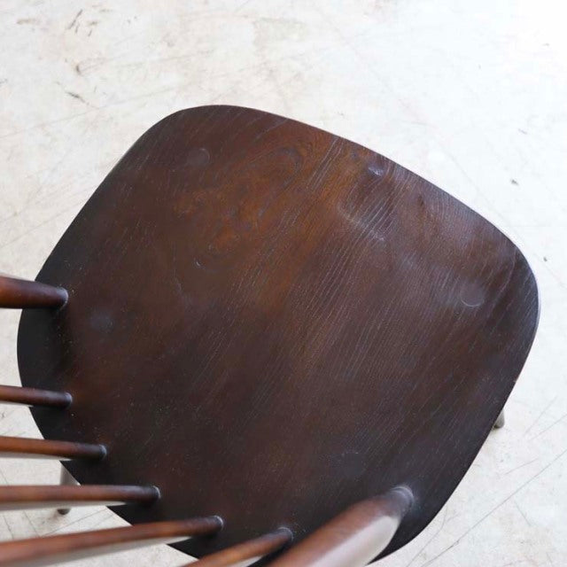 Vintage British mid-century teak dining chair seat with smooth curved edges and visible wood grain.