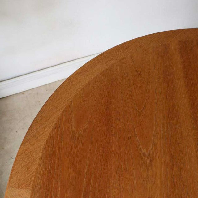 Round vintage teak dining table with smooth wood grain and clean mid-century British design.