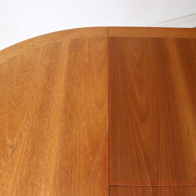 Vintage teak round dining table top with visible wood grain and smooth mid-century British design details.
