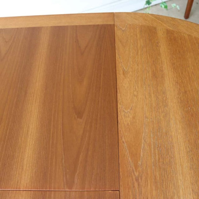 Vintage teak Nathan round dining table top with rich wood grain and mid-century British-Denmark design.