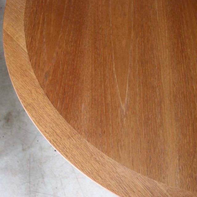 Vintage teak round mid-century dining table top showing rich wood grain and smooth finish from British-Danish design.