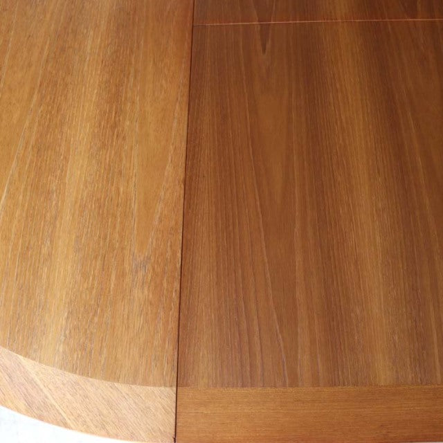 Vintage teak round dining table top with rich wood grain and mid-century British design details.