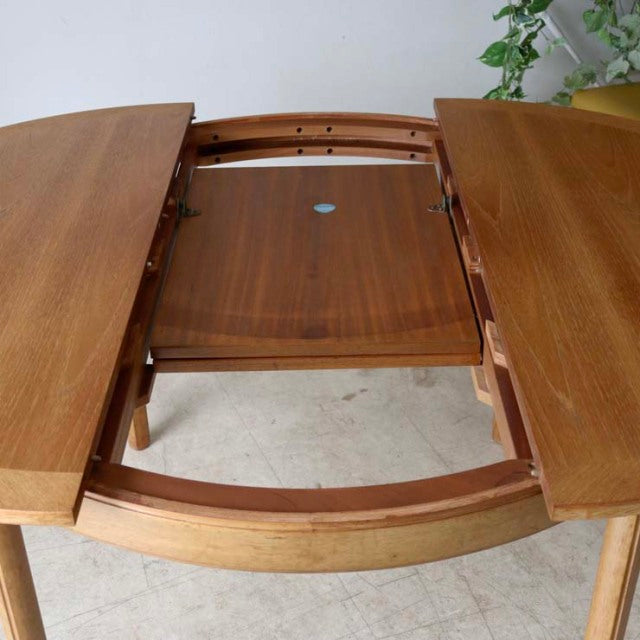 Mid-century British vintage teak dining table by Nathan with rounded edges and smooth wood grain, featuring extendable.