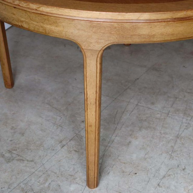 Vintage teak round dining table by Nathan featuring finely grained wood and slender tapered legs with British mid-century.