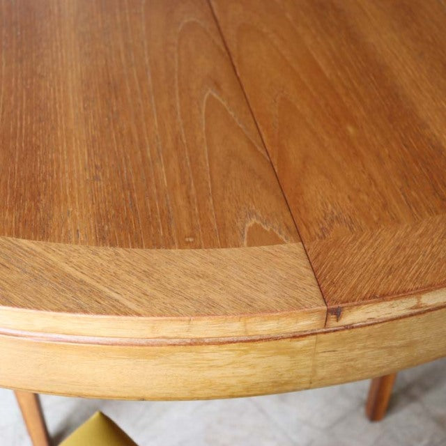 Vintage teak Nathan round dining table top with visible wood grain and smooth mid-century British design edges.