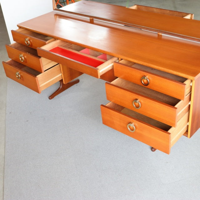 Mid-century British vintage teak dresser by Austinsuite with six drawers, brass ring handles, and smooth wood grain finish.