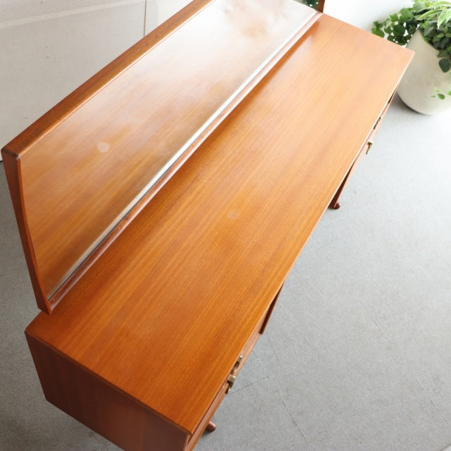 Mid-century British vintage teak dresser by Austinsuite with smooth wood grain and clean lines.