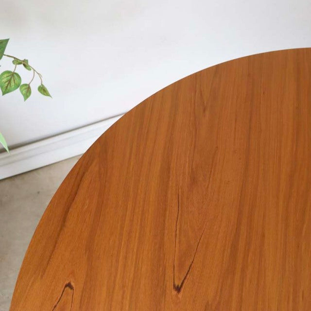 Vintage Alfred Cox round teak dining table with smooth wood grain and mid-century British-Denmark design.