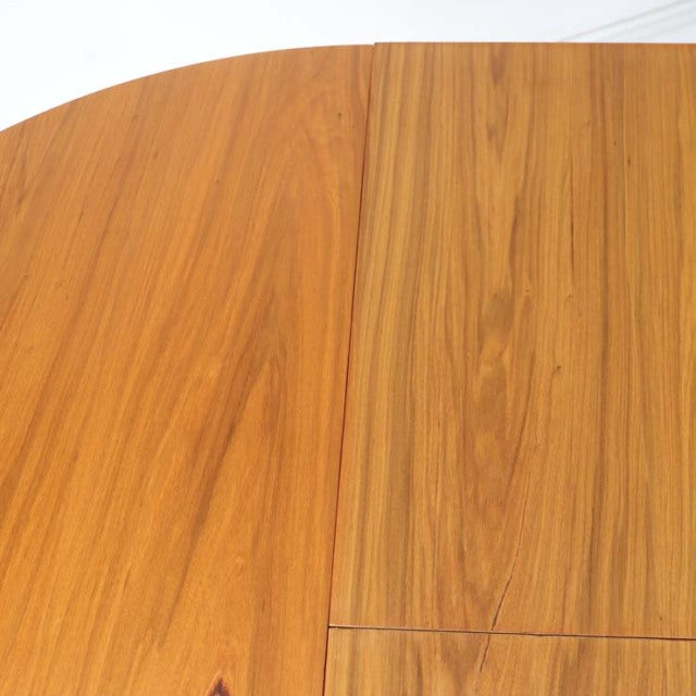 Round vintage teak dining table by Alfred Cox with smooth grain and mid-century British-Danish design.