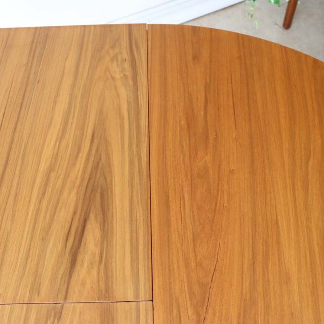 Round vintage teak dining table top with rich wood grain and smooth finish by Alfred Cox, British mid-century design with.
