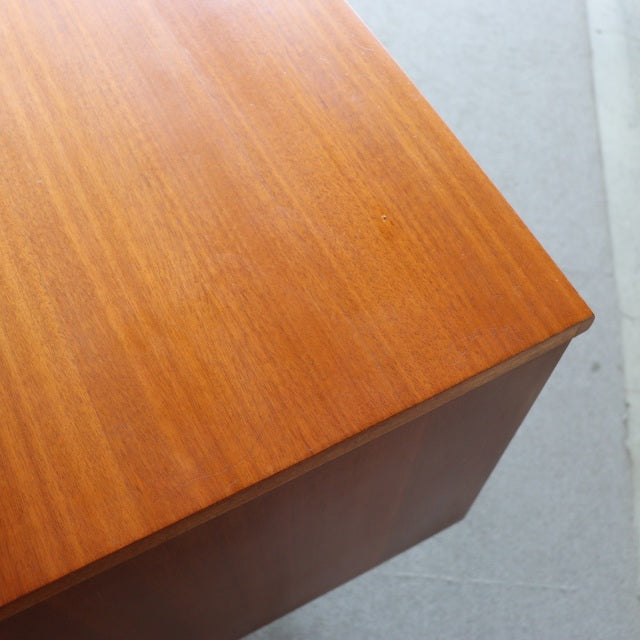 Close-up of vintage British mid-century Austinsuite dresser corner in teak wood with smooth grain and warm finish.