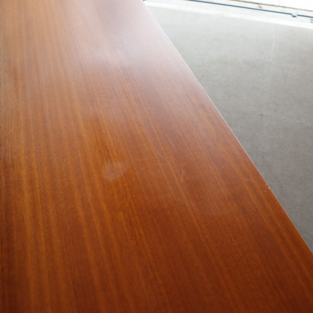 Vintage teak wood surface with warm mid-century British-Denmark grain pattern and smooth finish.