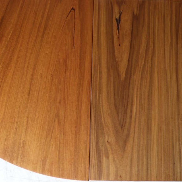 Vintage teak round dining table top with rich wood grain and subtle mid-century British craftsmanship from Alfred Cox,.